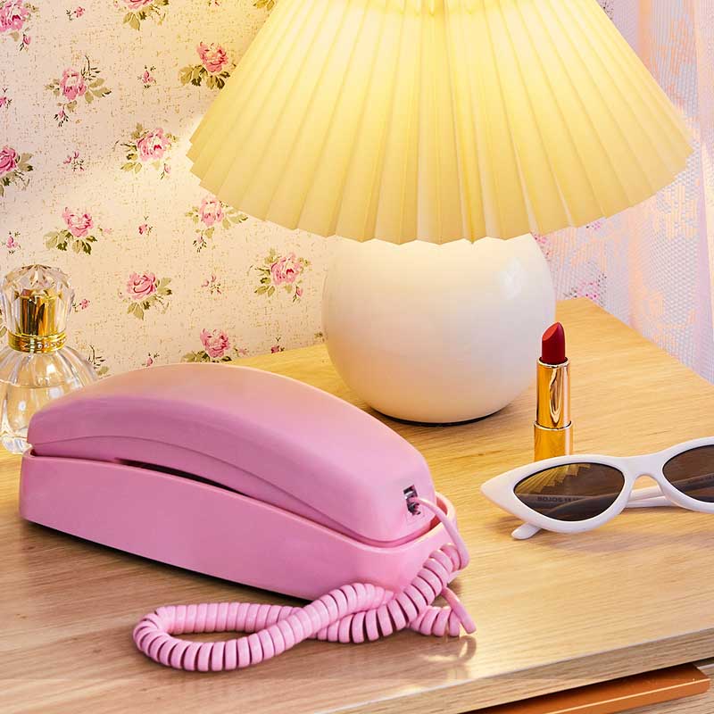 An image of Ooma Telo with Retro Pink Phone on a table.